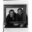 Portrait of Wayne and Shuster inside picture frame, [ca. 1970]. Ontario Jewish Archives, Blankenstein Family Heritage Centre, fonds 37, series 4, item 7. Photo by Al Gilbert|Wayne and Shuster met in the tenth grade at Harbord Collegiate in Toronto. Both went to the University of Toronto for degrees in English Literature. In 1941, they started a show called Wife Preservers for CFRB, after which they started writing and performing a comedy show called the Wayne and Shuster show for the CBC's Trans-Canada Network. In 1942, they both joined the infantry and were stationed to perform for the Army Show travelling across Canada to different military bases. They took the show to Normandy after D-Day and wrote a 52 week series for veterans and spent six weeks entertaining the Commonwealth Division in Korea. In 1946, they returned to the CBC performing the Wayne and Shuster Show on the radio. In 1958 they appeared on the Ed Sullivan Show in the United States of America; in fact, they became a regular feature on Ed Sullivan, breaking the record for the number of appearances for any one guest. Wayne and Shuster created numerous hour long television shows for the CBC, and were a Sunday night fixture for many years to follow. Wayne and Shuster's comedy has been described as literate slapstick.